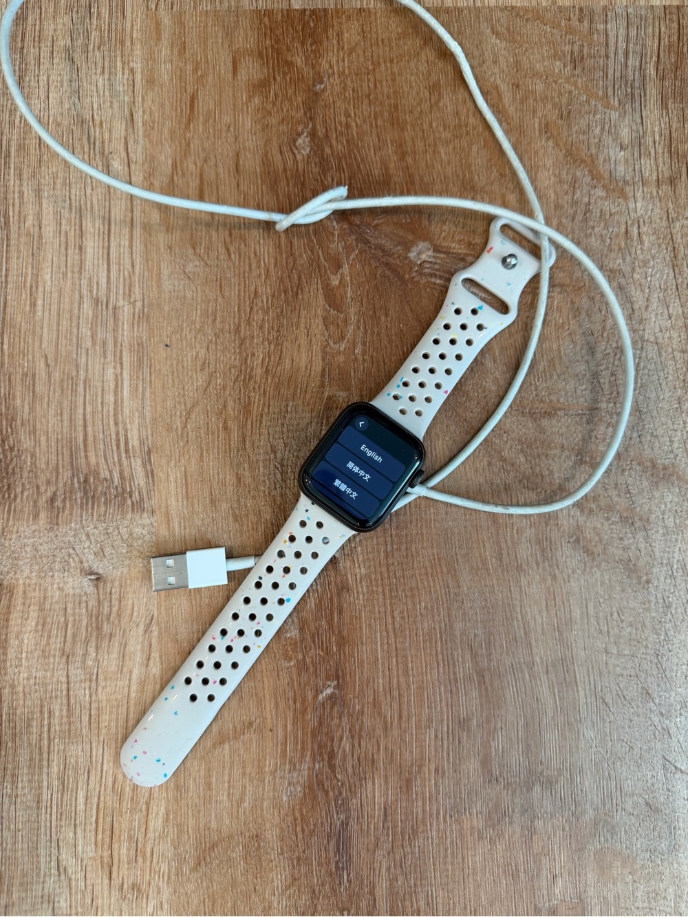 Apple Watch with White Speckled Sport Band and Charging Cable - Picture 3 of 3